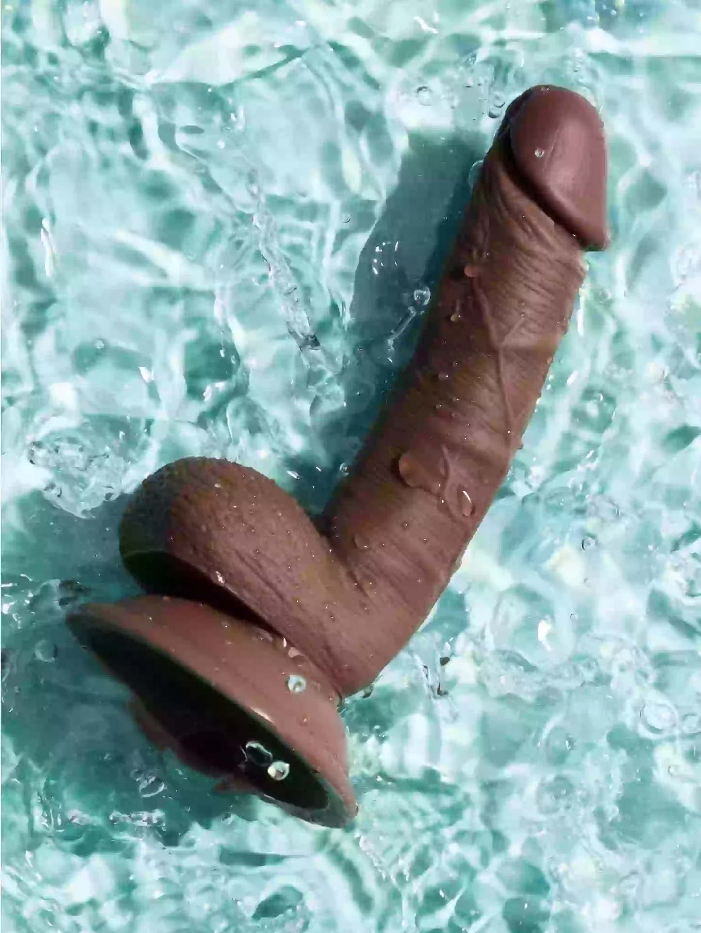 Brown object resembling a penis on a textured blue surface