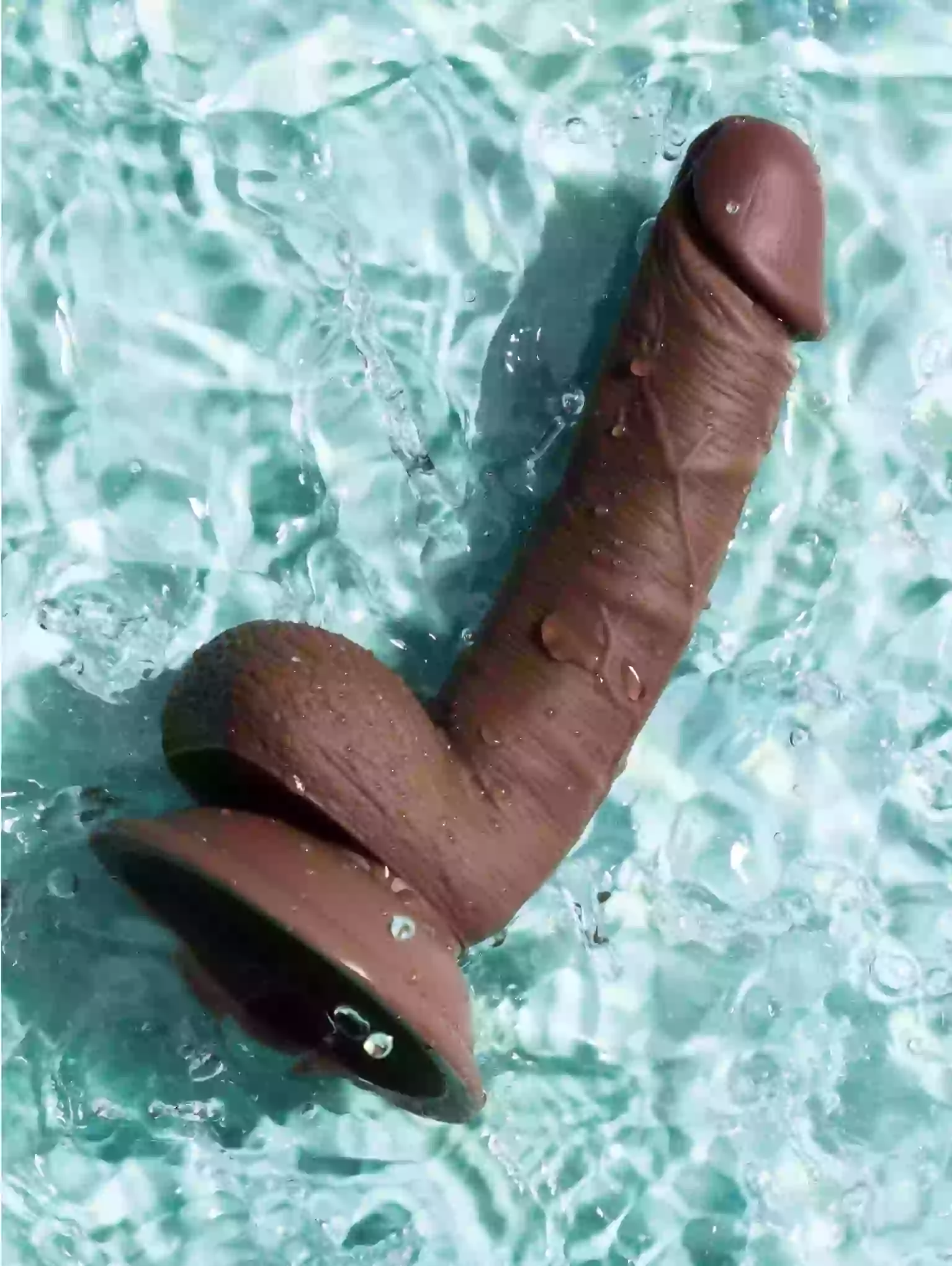 Brown object resembling a penis on a textured blue surface