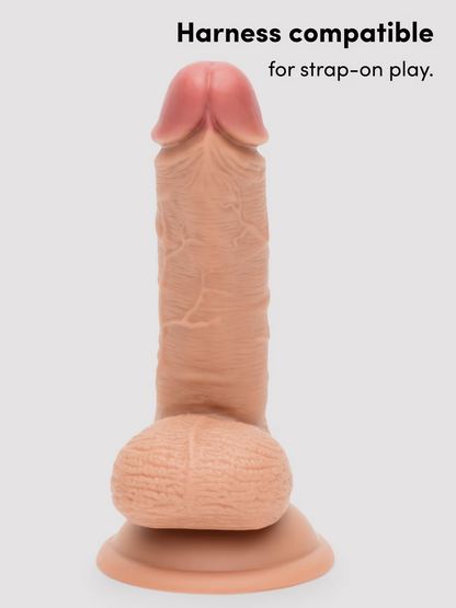 Sexual product with 'Harness compatible for strap-on play' text on a white background