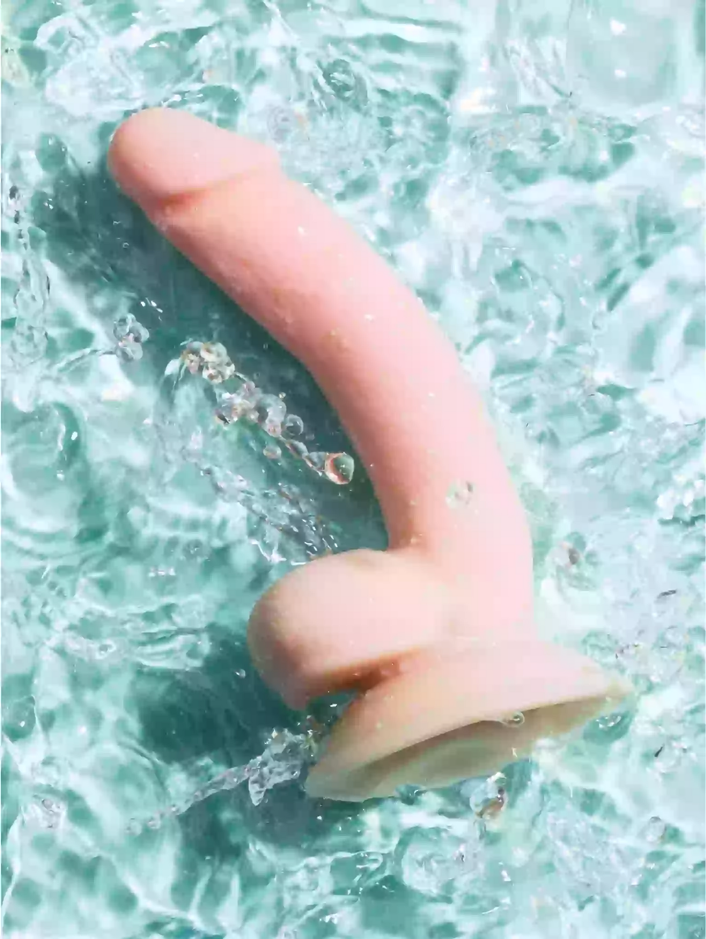 Pink rubber duck floating in water with ripples