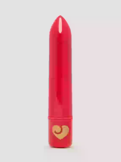 Red lipstick with a gold heart on a light gray background
