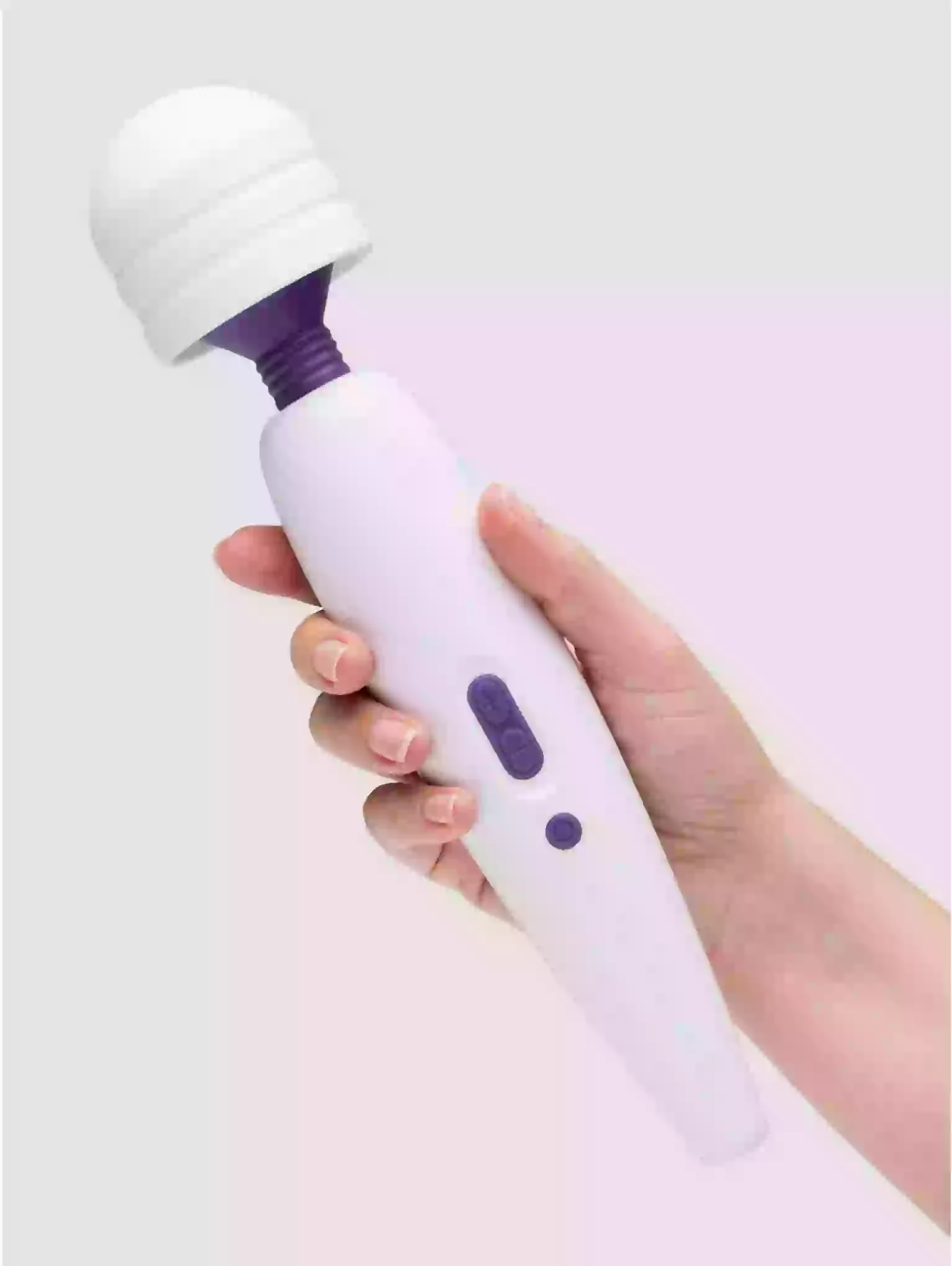 Hand holding a white and purple handheld device on a light gray background