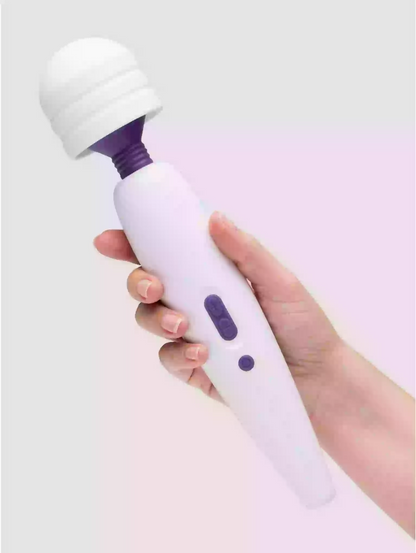 Hand holding a white and purple handheld device on a light gray background