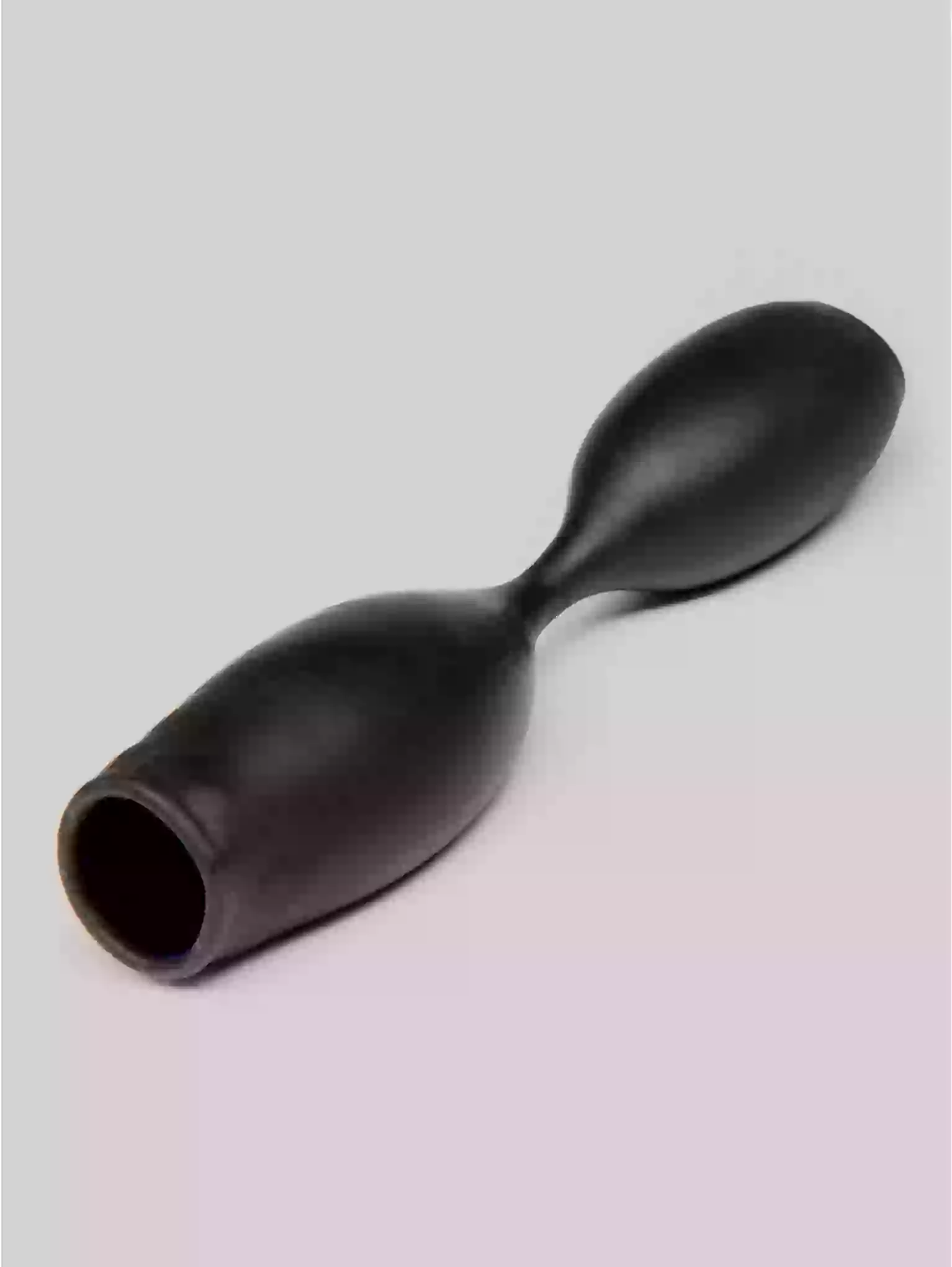 Black plastic tool on a gradient background