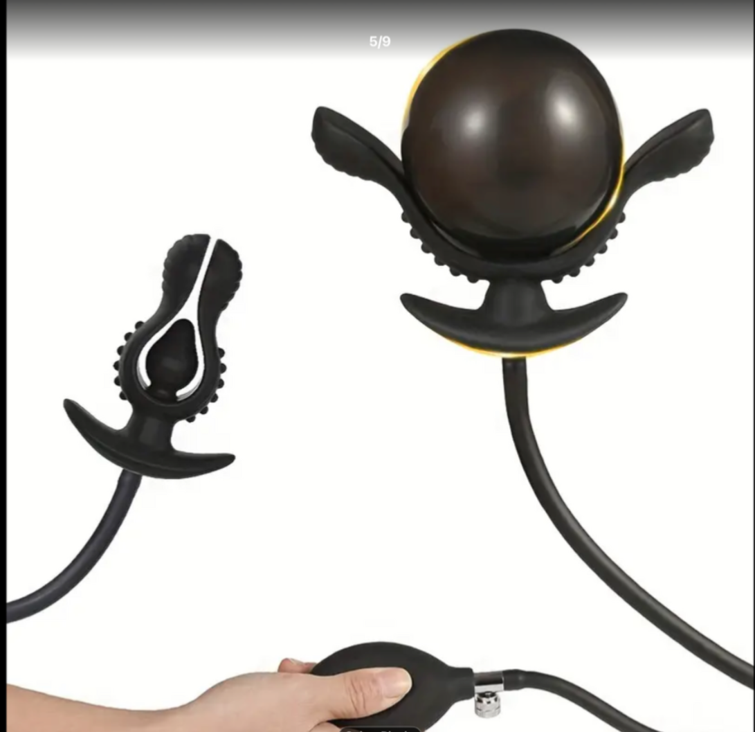 Black and yellow massage tool held by a hand on a white background