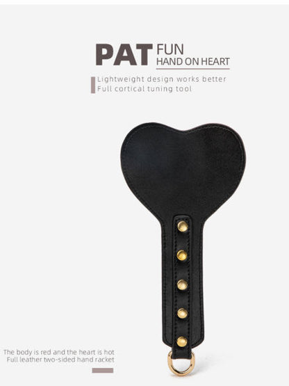 Black heart-shaped tool with gold accents on a white background