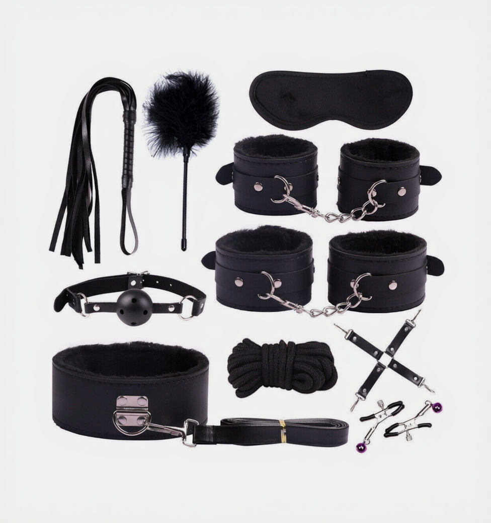 Collection of black bondage accessories on a white background