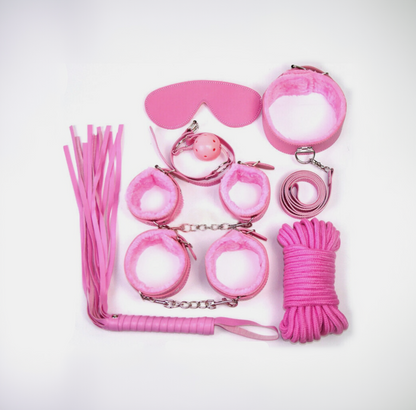 Collection of pink bondage accessories on a white background