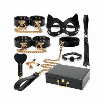 Collection of black and gold bondage accessories with a box on a white background