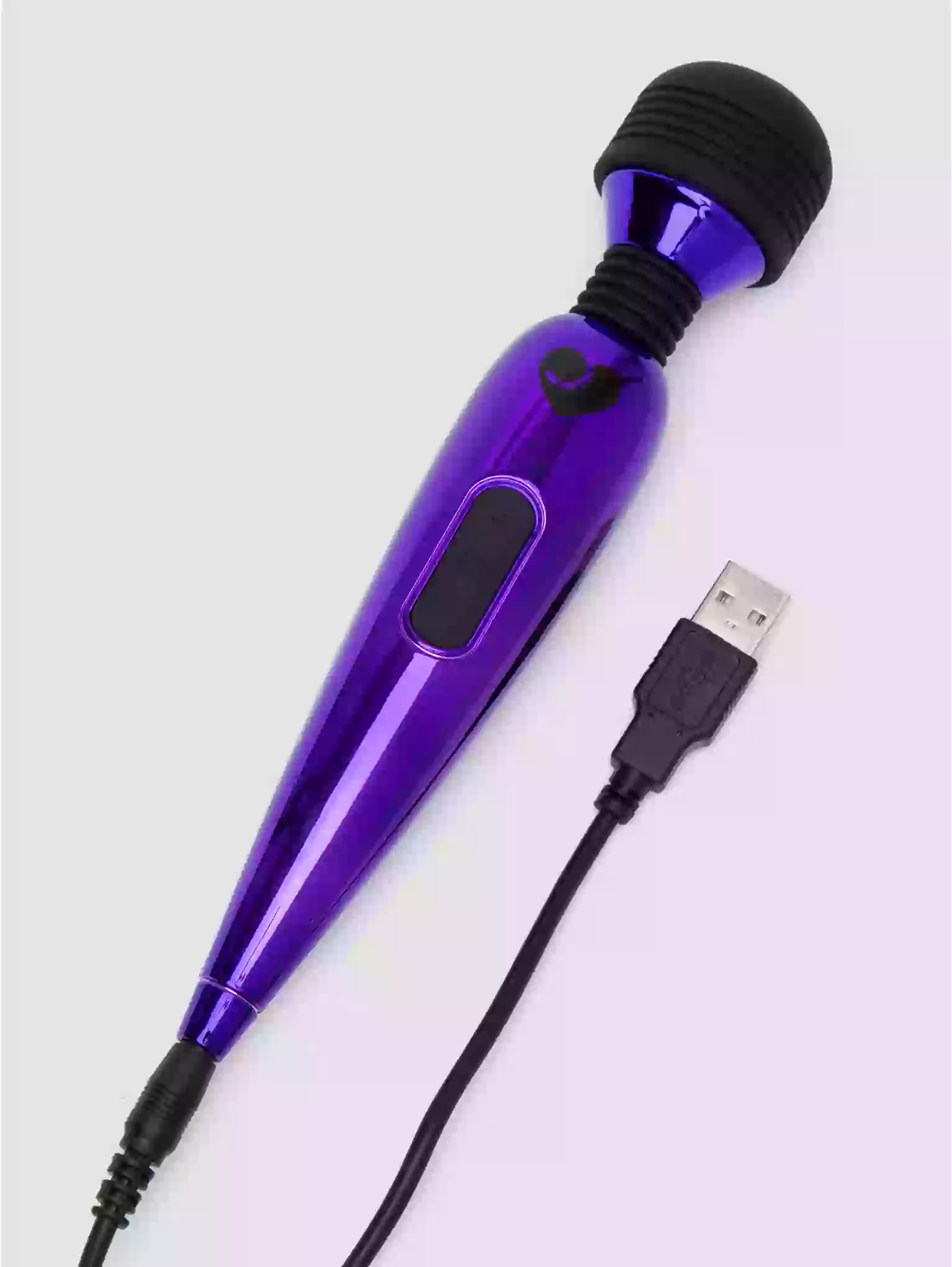 Purple handheld device with black attachments and USB cable on a light gray background