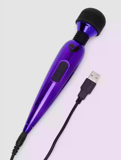 Purple handheld device with black attachments and USB cable on a light gray background