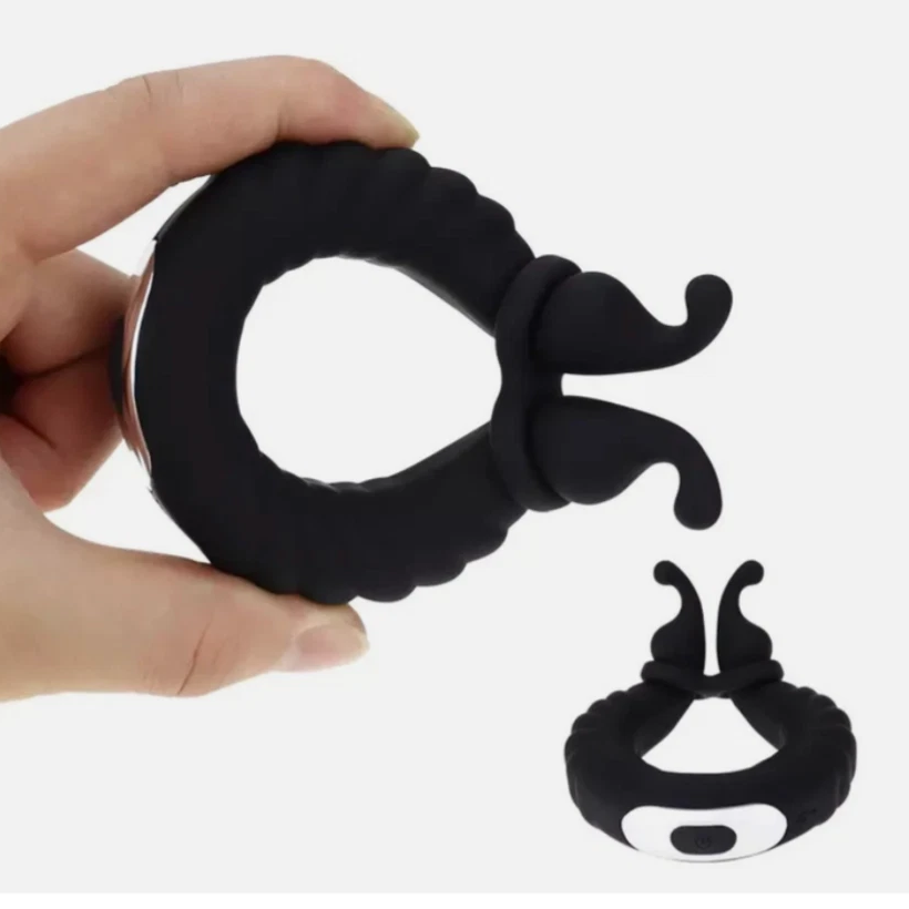 Black silicone ring with a unique design held by a hand on a white background