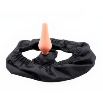 Black rubber ring with a beige object inside on a white background