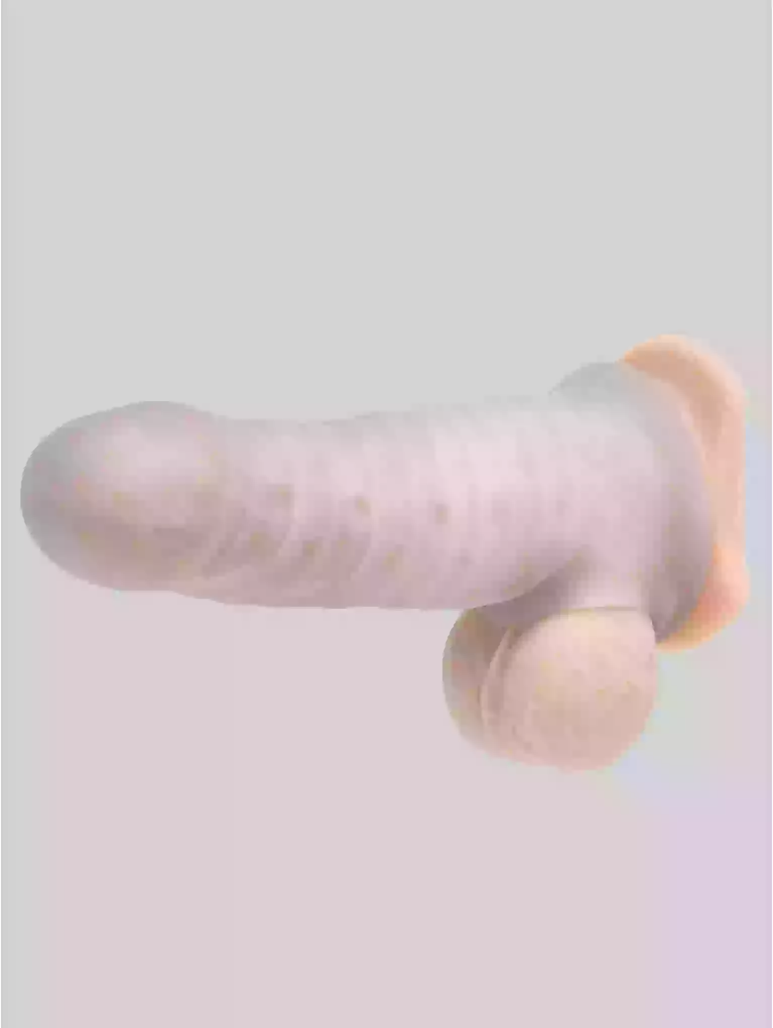 Pink and beige toy on a light gray background