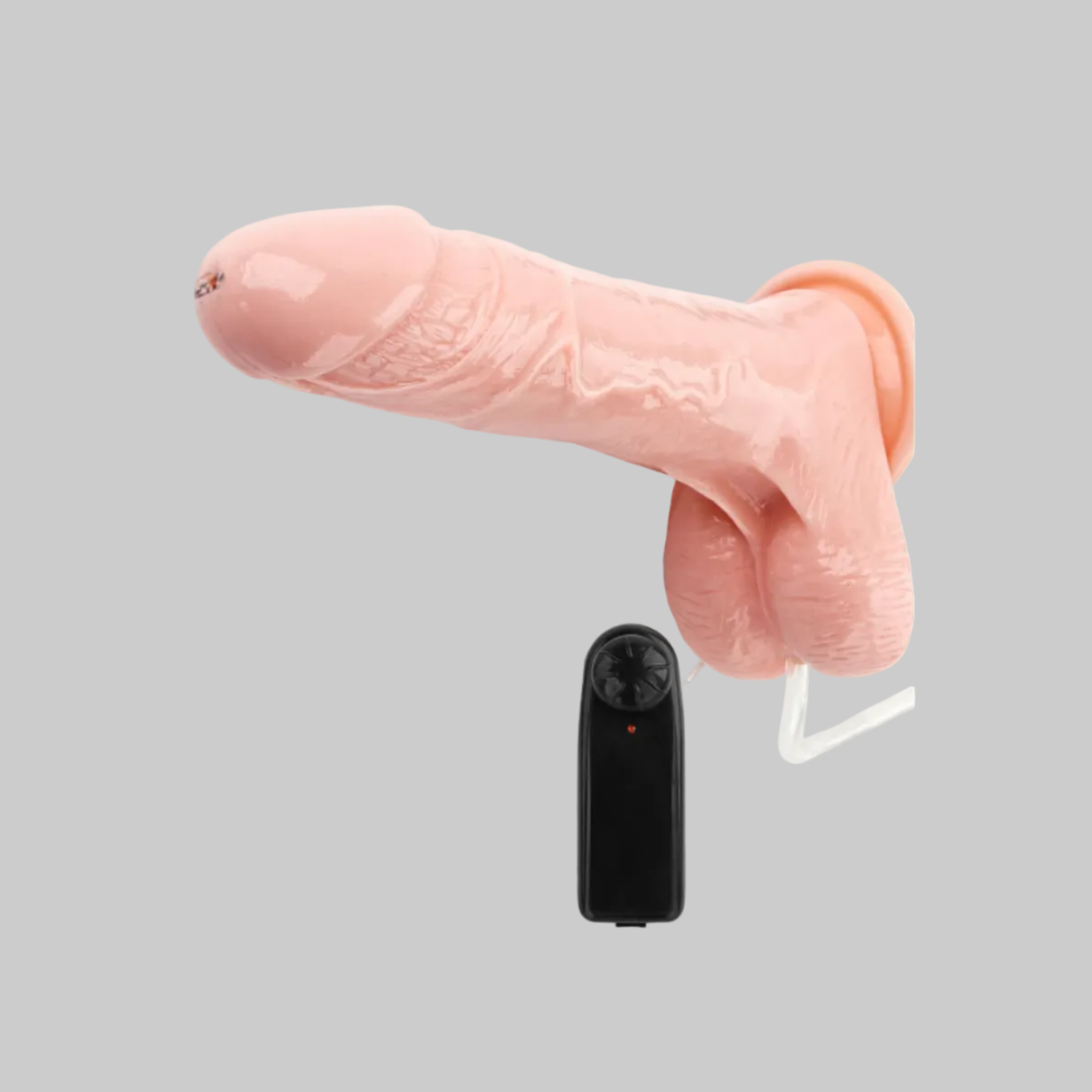 Pink silicone product with remote control on a gray background