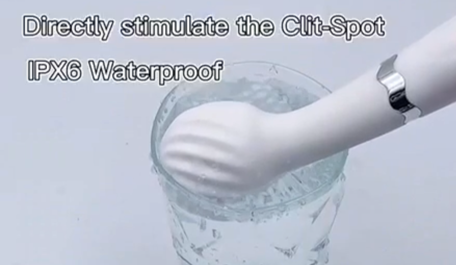 White electronic device with water droplets being tested for waterproofing on a light gray background.