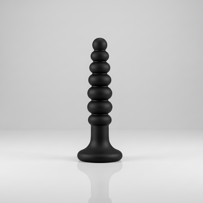 Black, cylindrical object with stacked spheres on a white background