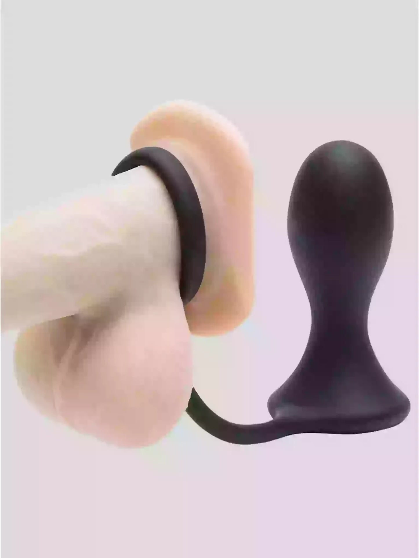 Two silicone butt plugs in beige and black on a light gray background