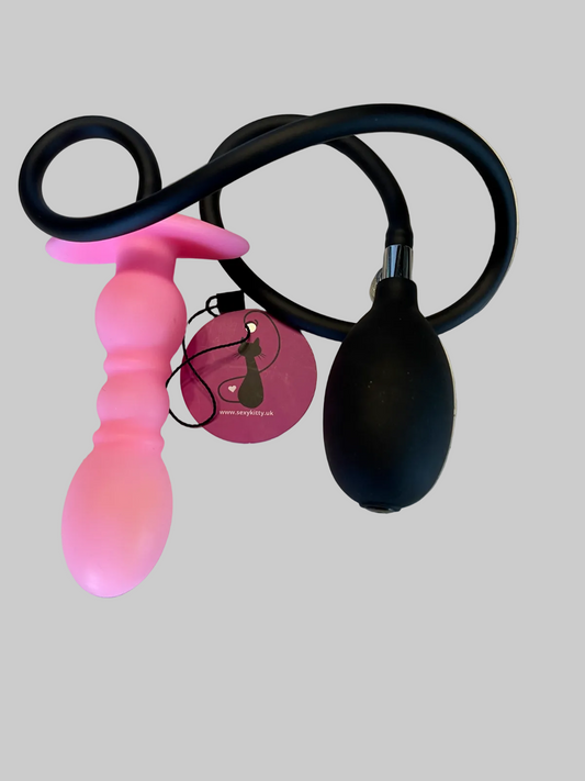 Pink and black silicone butt plug with black pump on a gray background