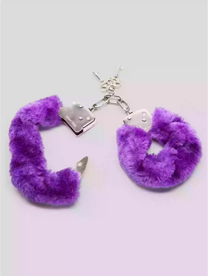Purple fuzzy handcuffs keychain on a light gray background