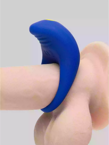 Blue silicone ring on a finger against a gray background