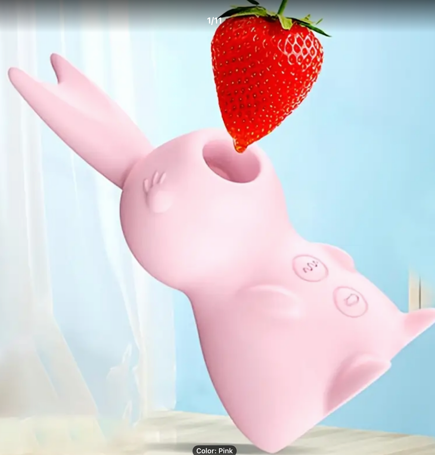 Pink rubber glove holding a strawberry against a light blue background