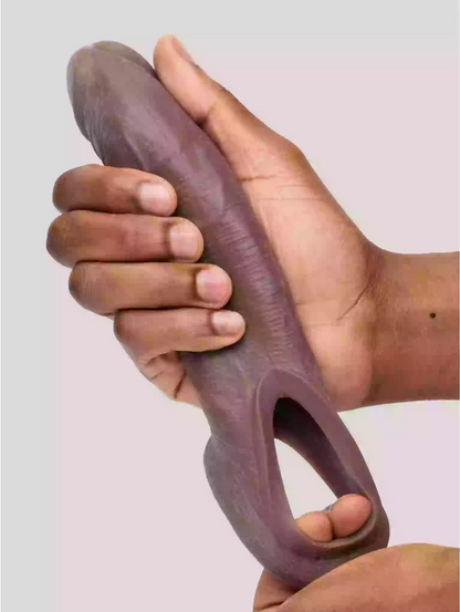 Hand holding a purple silicone tool against a plain background