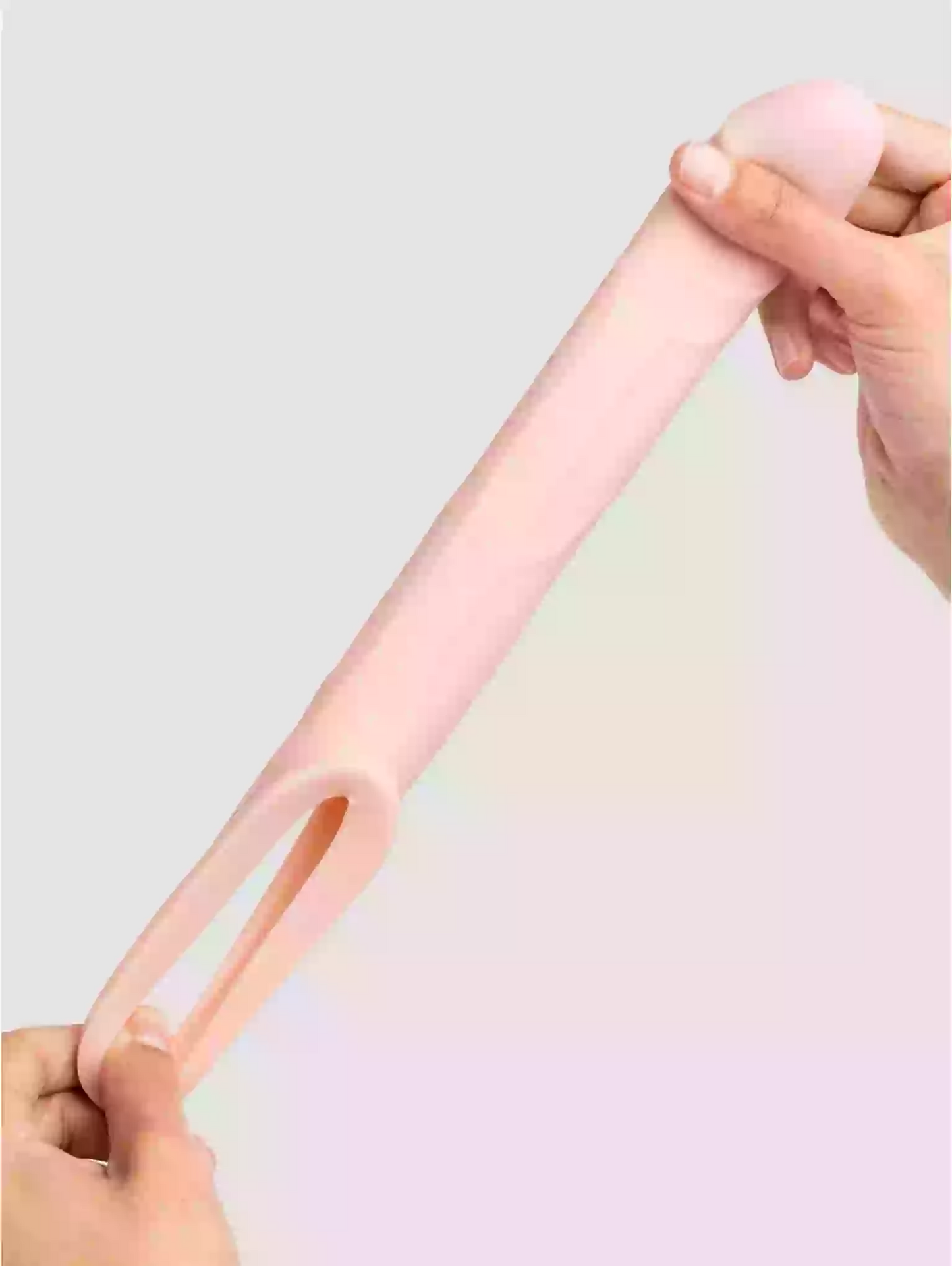 Pink slinky toy being stretched by hands on a light gray background