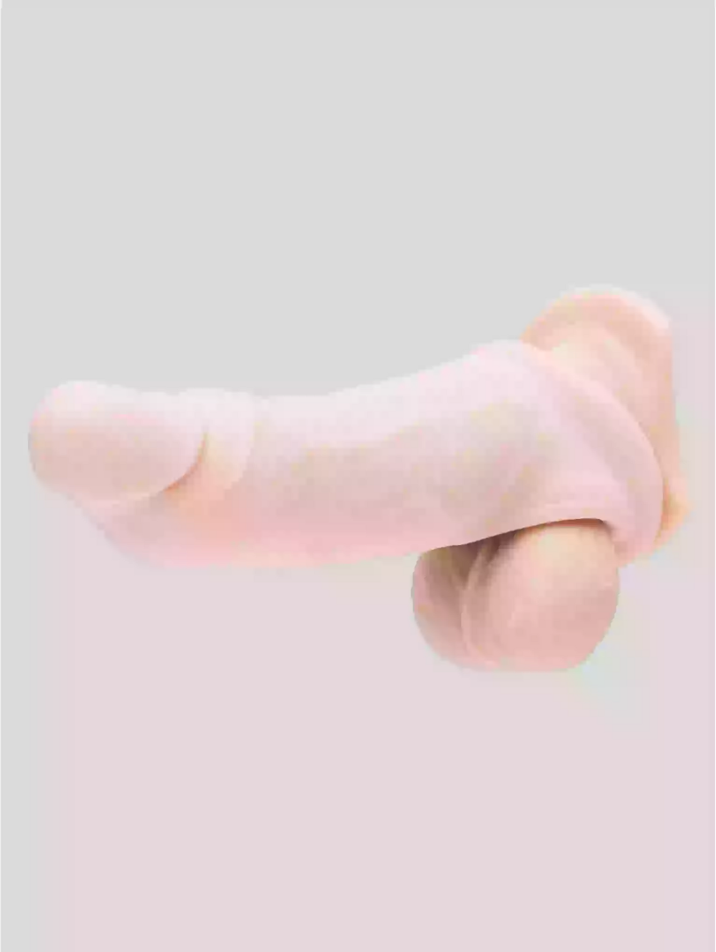 Close-up of a pink silicone ring on a light gray background