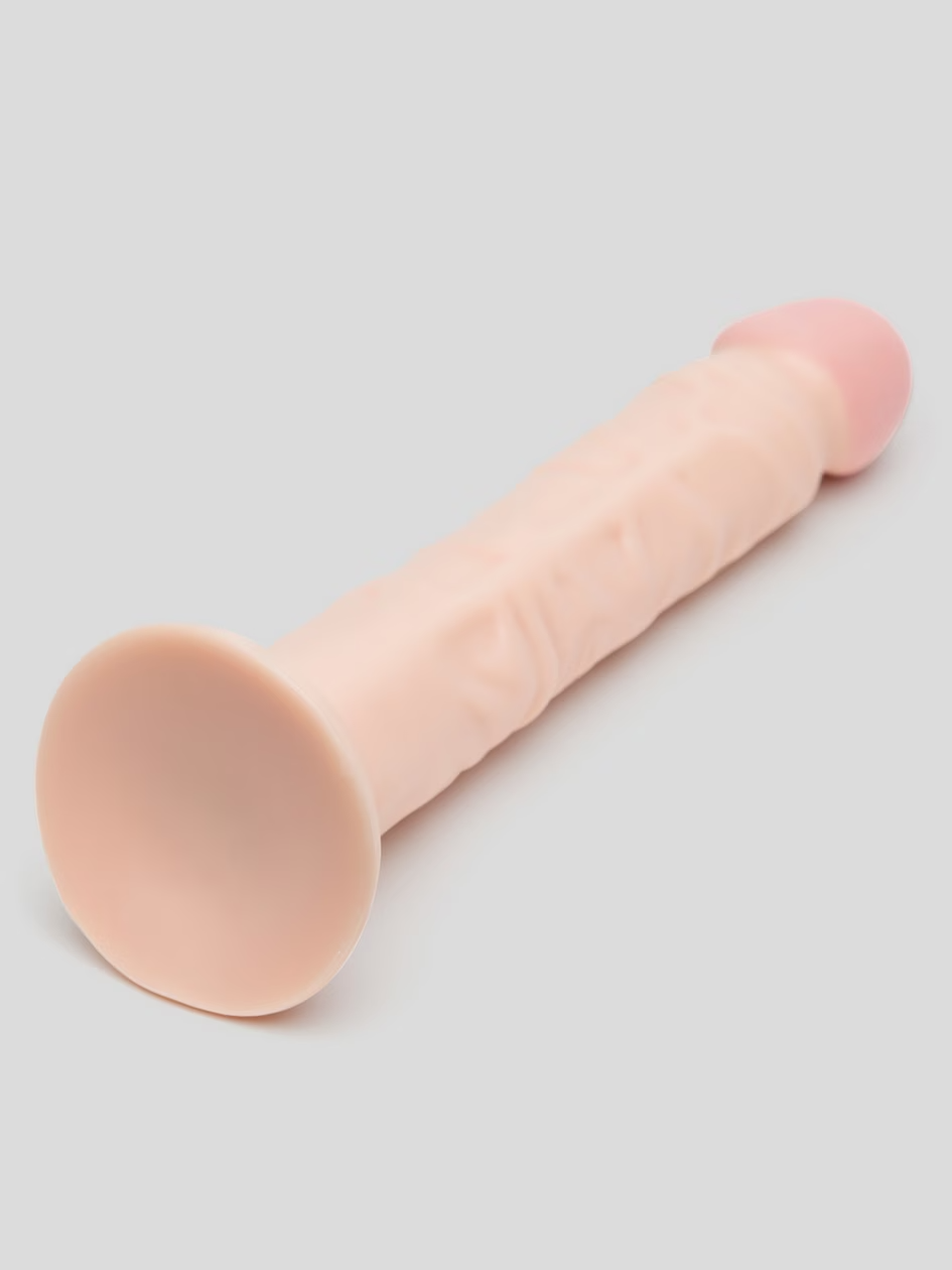 Pink makeup brush on a light gray background
