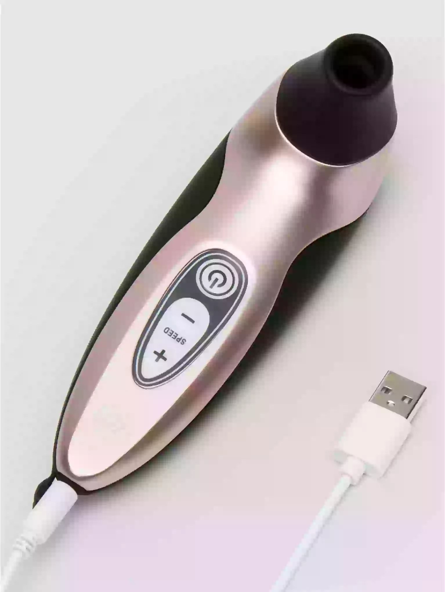 Beauty device with USB cable on a light gray background