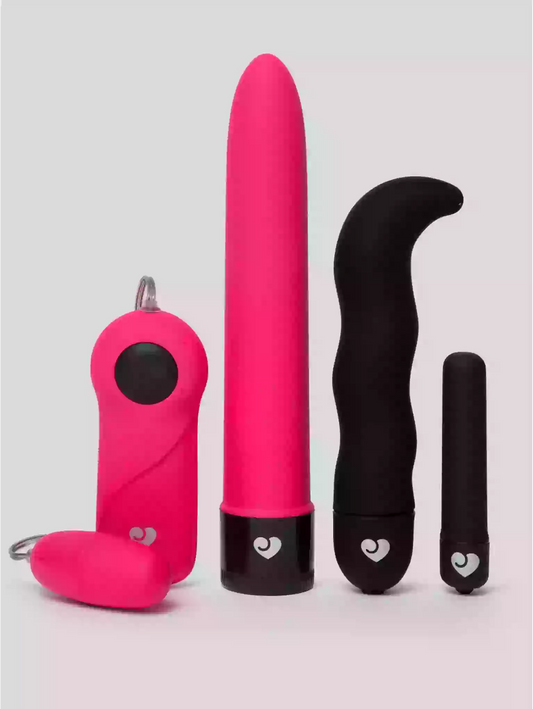 Set of pink and black sex toys on a light gray background