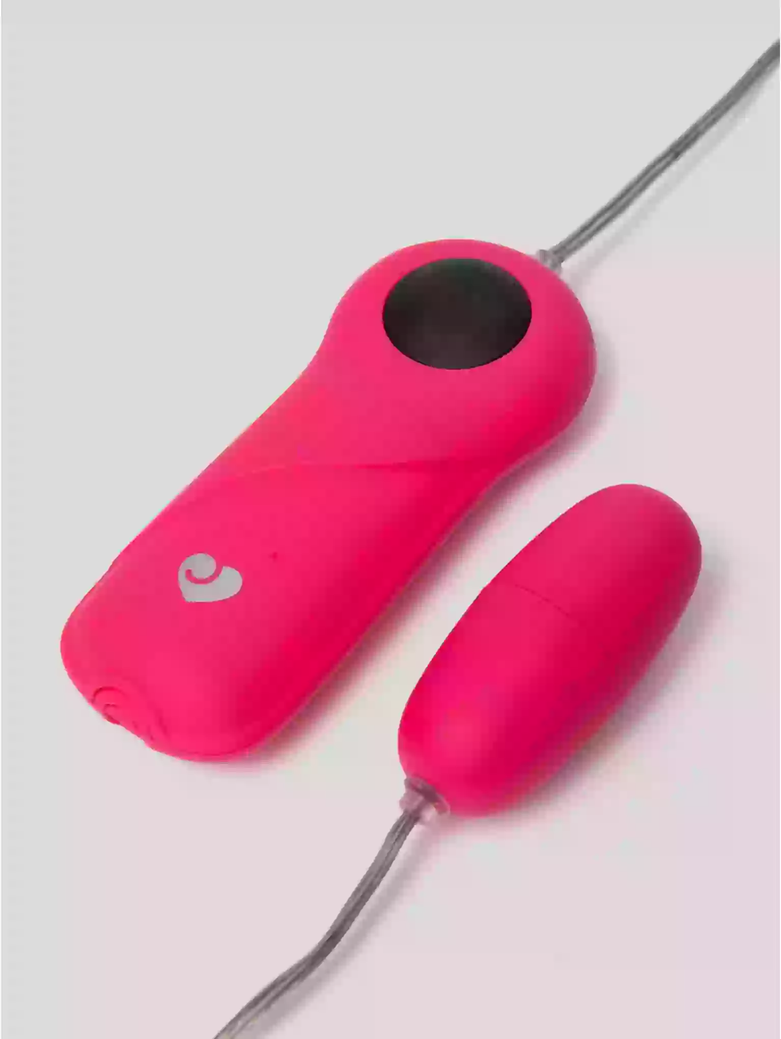 Pink electronic device with a heart logo on a light gray background
