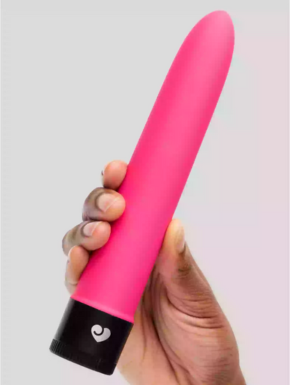 Hand holding a pink and black object with a heart symbol on a light gray background