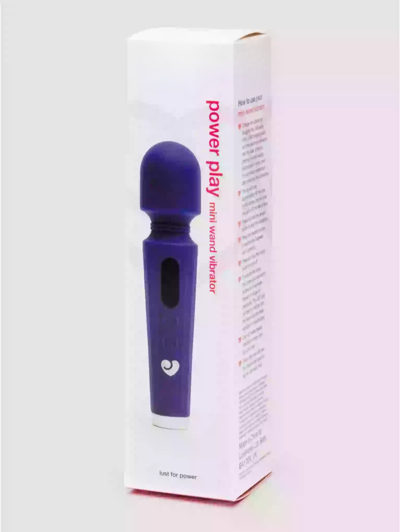 Purple mini hand vibrator with packaging on a white background