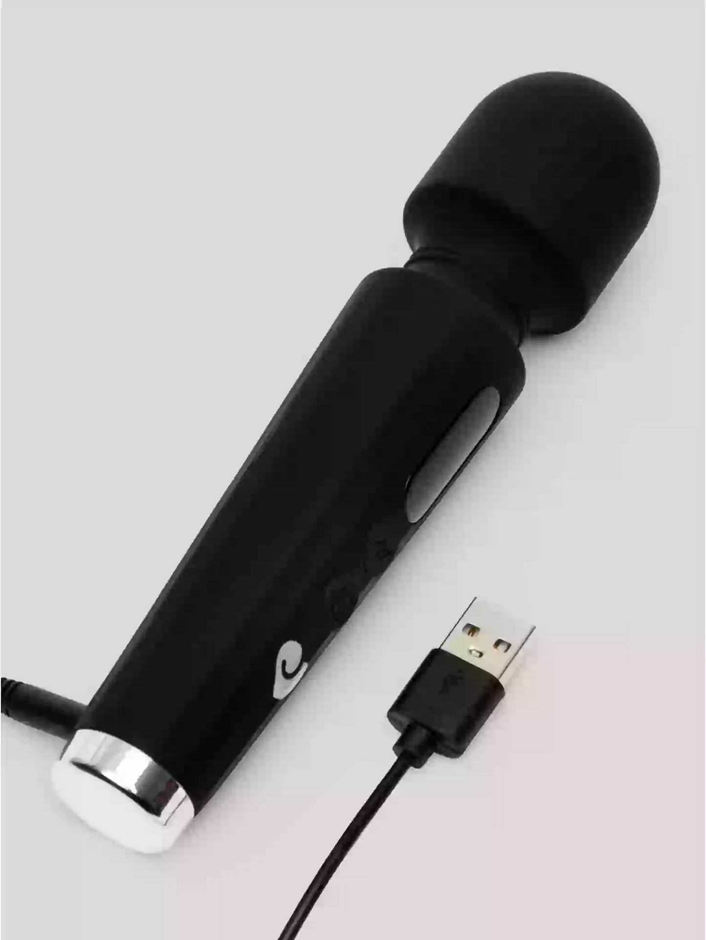 Black handheld electronic device with USB cable on a light gray background