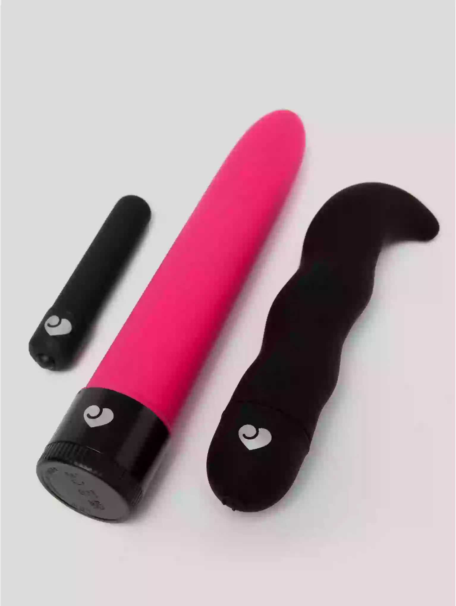Pink and black device with heart symbols on a light gray background