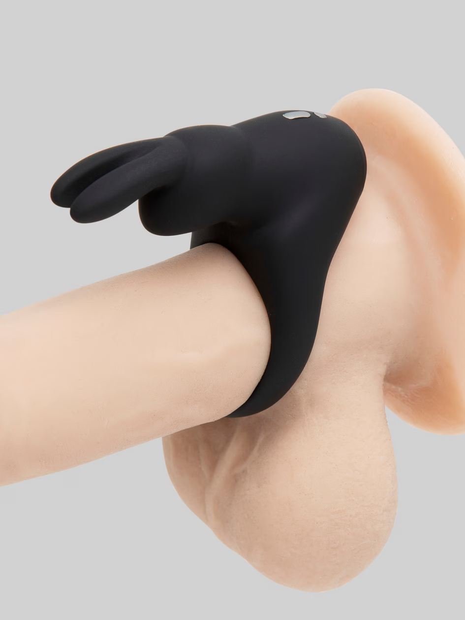 Black knee brace on a person's knee against a gray background