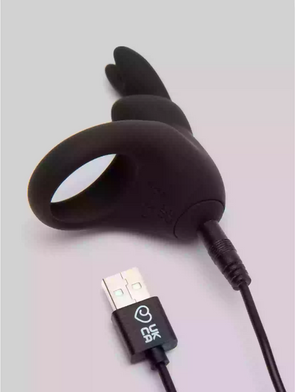Black USB charging cable with a heart logo on a light gray background