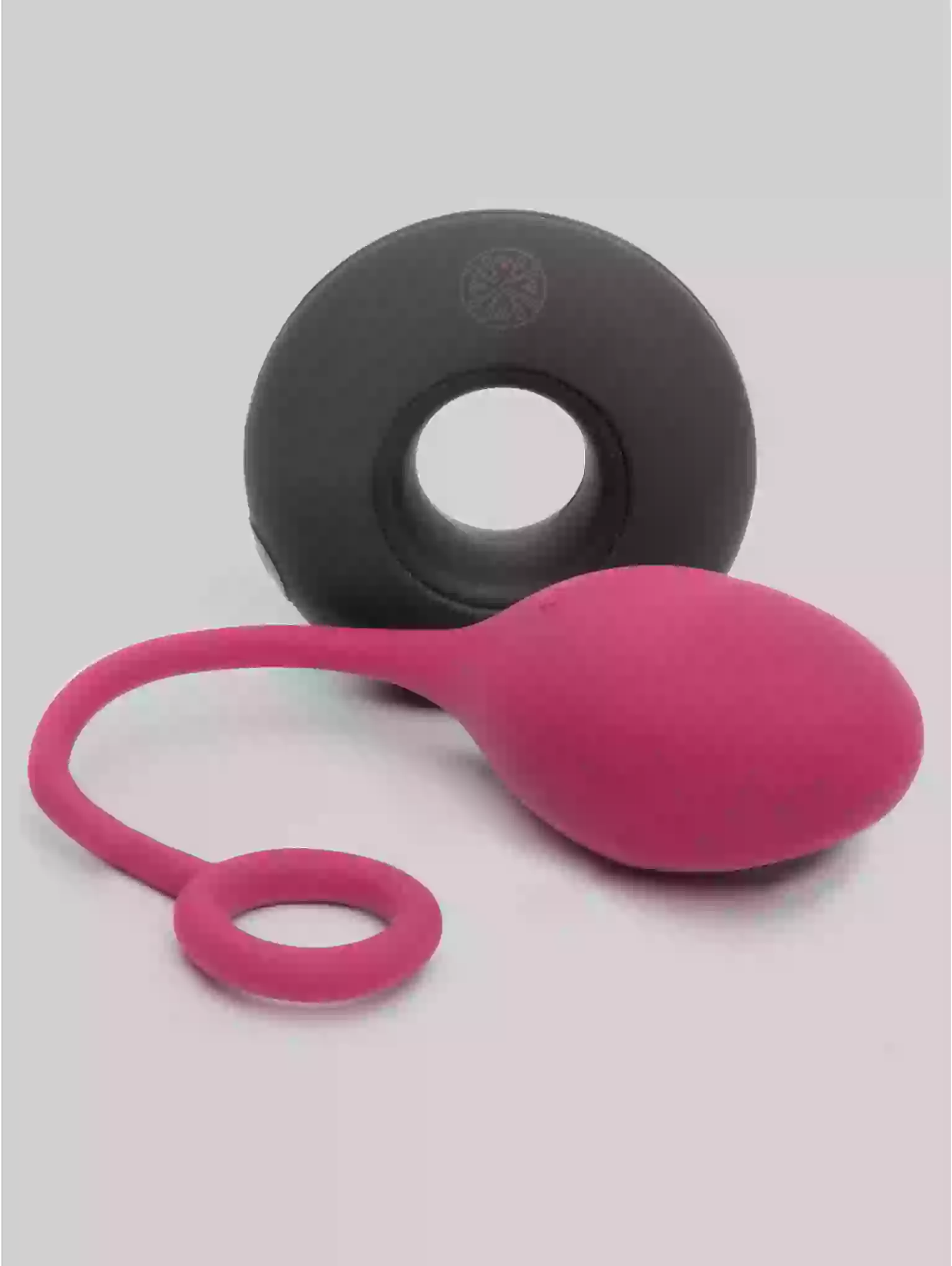 Pink and black silicone tool on a light gray background