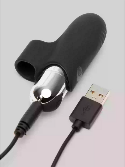 Black silicone sheath with metallic tip and USB cable on a light gray background