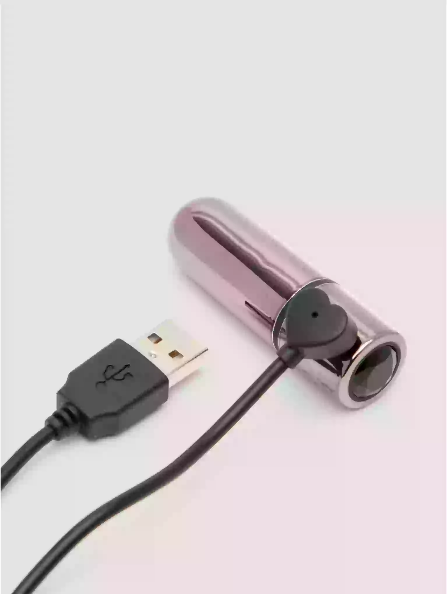 Metallic device with USB cable on a light gray background