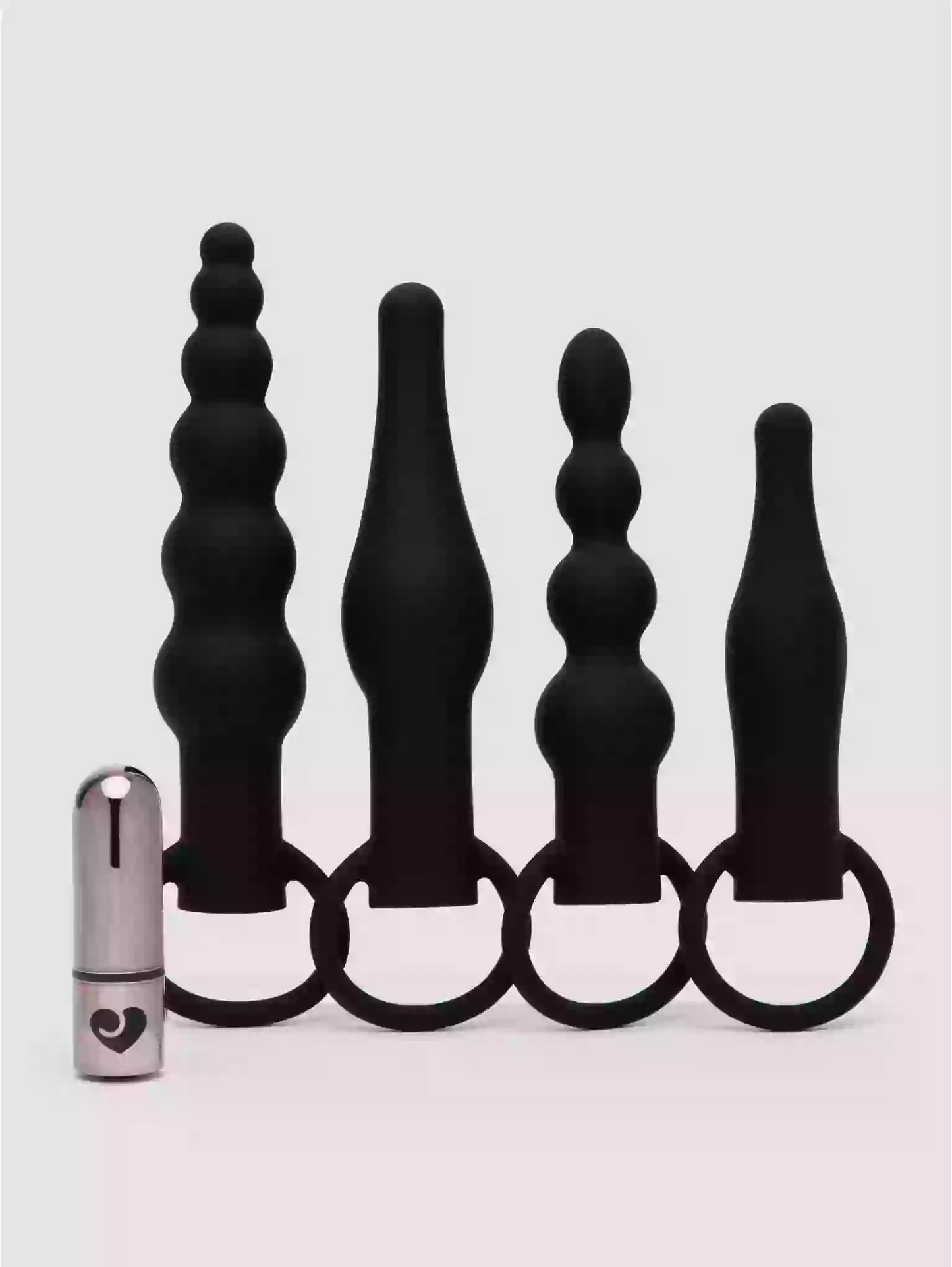 Set of black silicone butt plugs with a metal ring on a white background