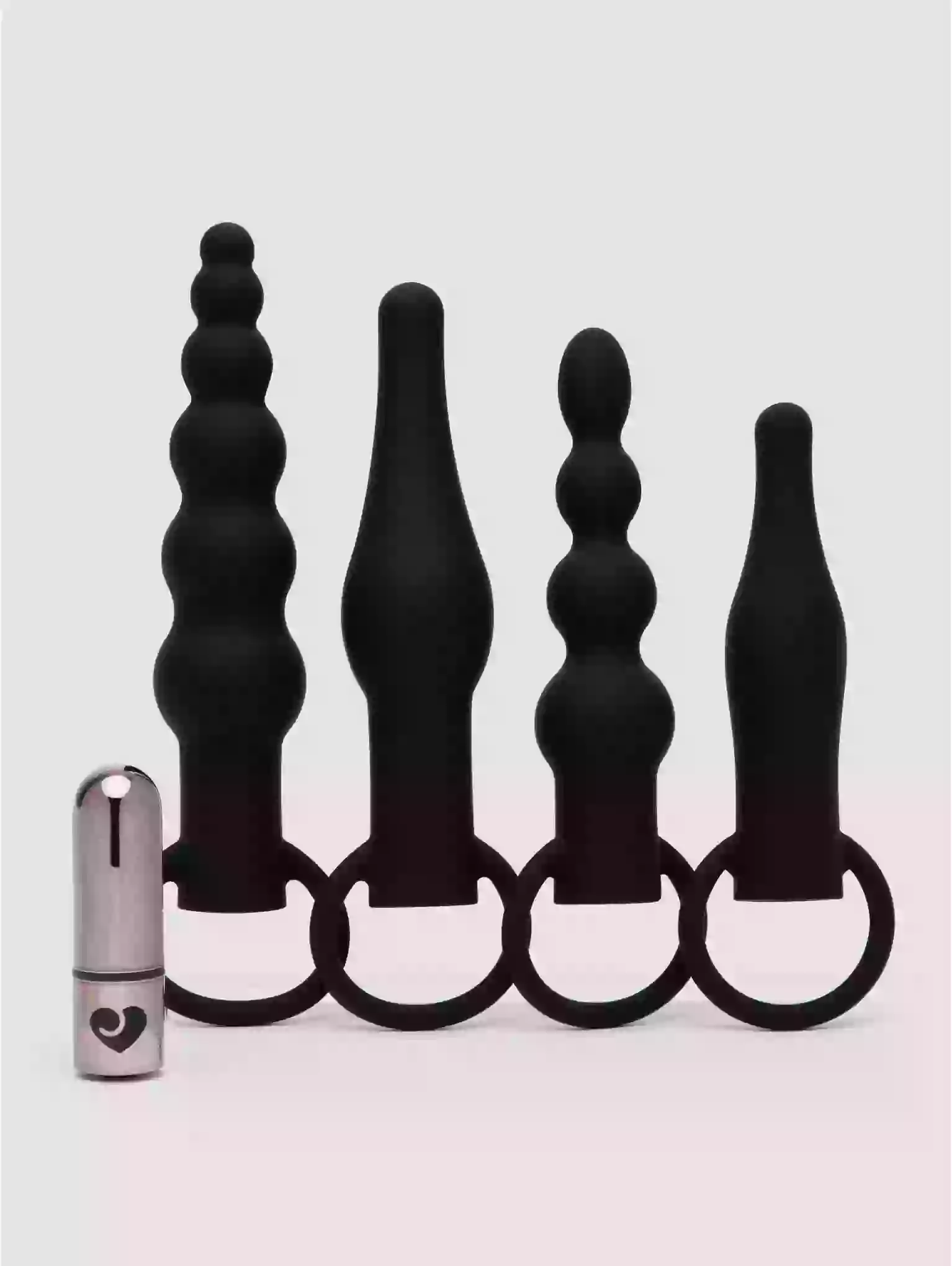 Set of black silicone butt plugs with a metal ring on a white background