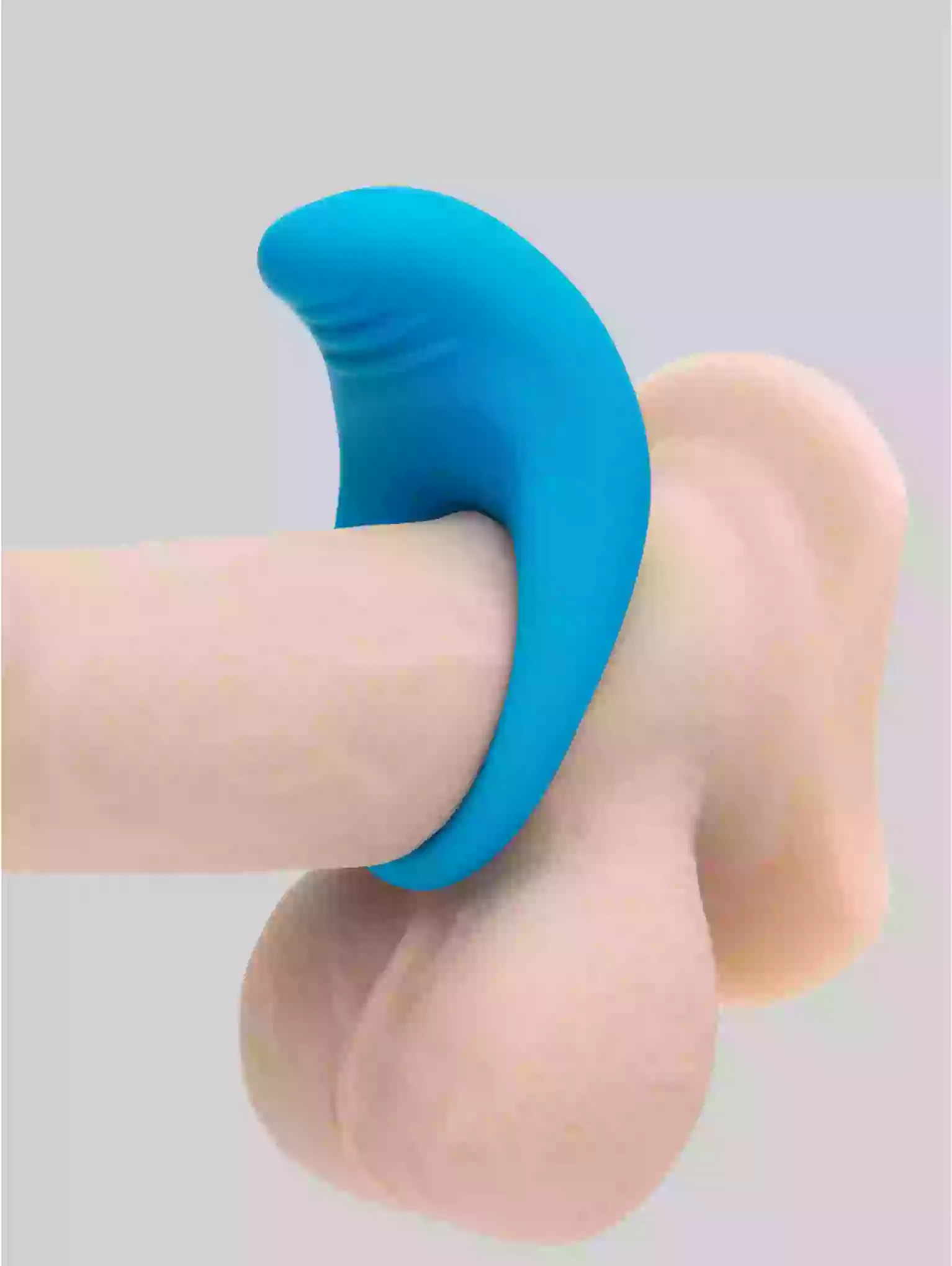 Blue silicone ring on a finger against a light gray background