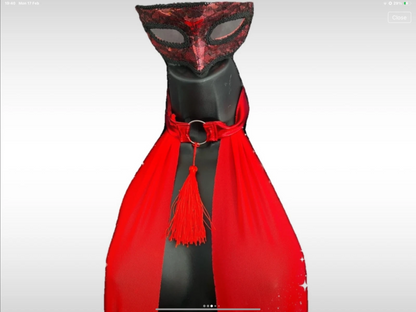 Mannequin wearing a red and black mask with a red scarf on a white background