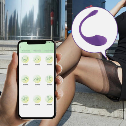 Person using a smartphone app with a blurred logo in the foreground, sitting outdoors.