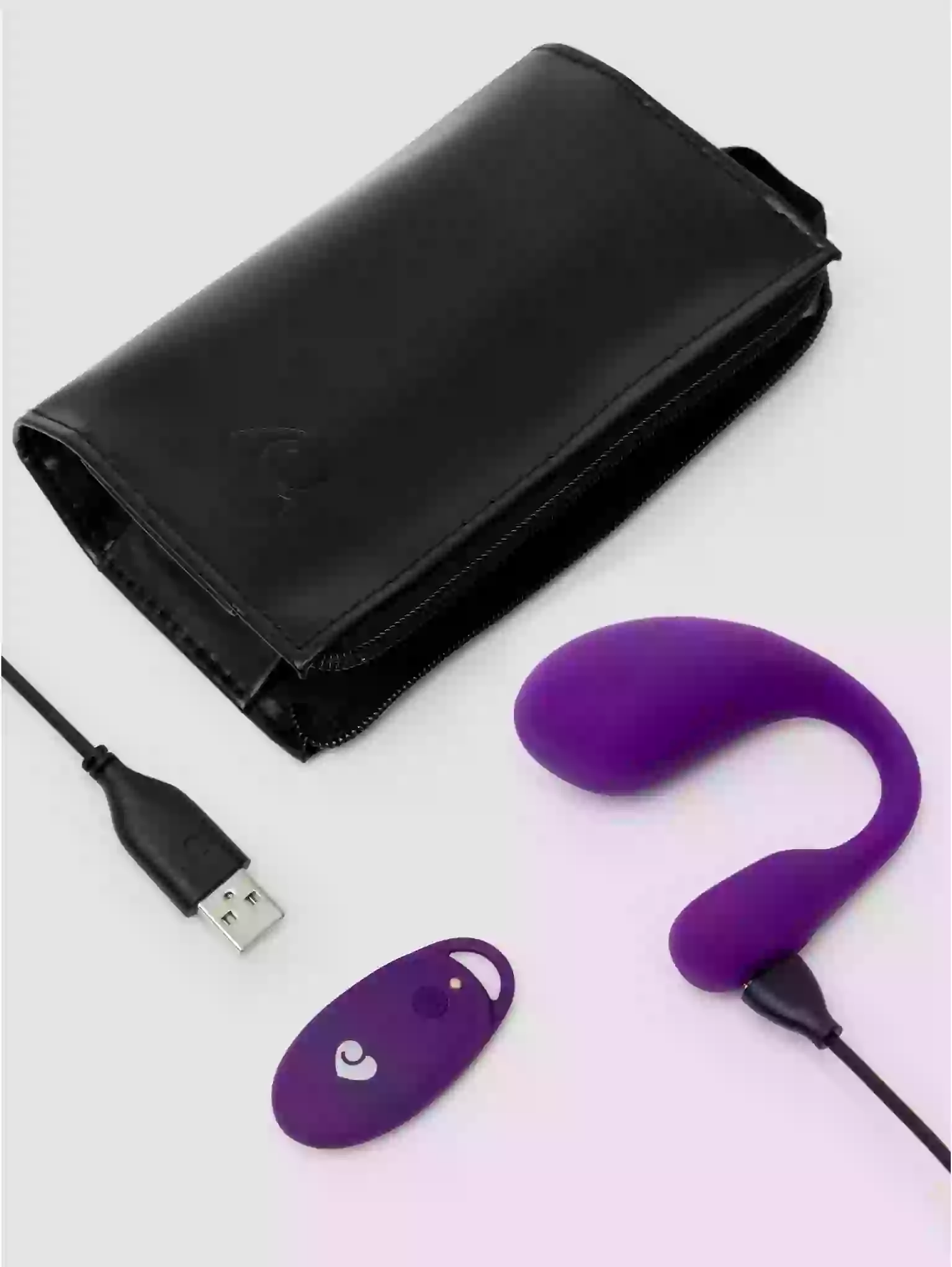 Purple electronic device with USB cable and black wallet on light gray background