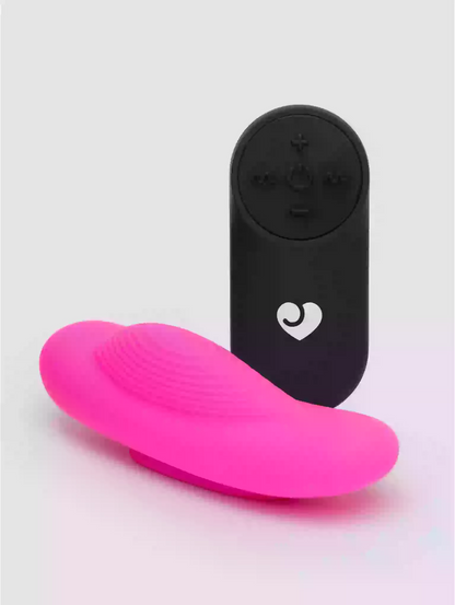 Black electronic device with a heart logo and pink silicone pad on a light gray background