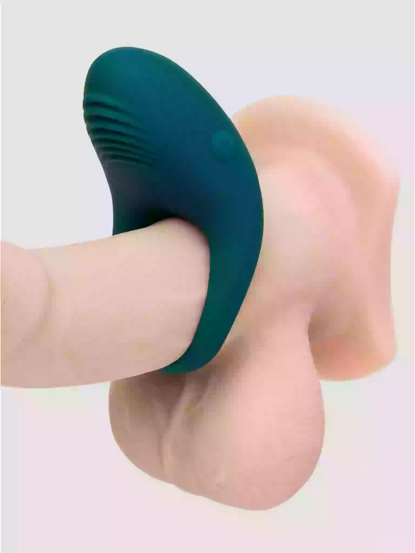 Teal silicone ring on a finger against a light background
